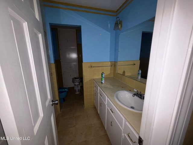4805 Washington Ave, Gulfport, MS 39507 - bathroom with vanity, tile patterned floors, tile walls, and a wainscoted wall