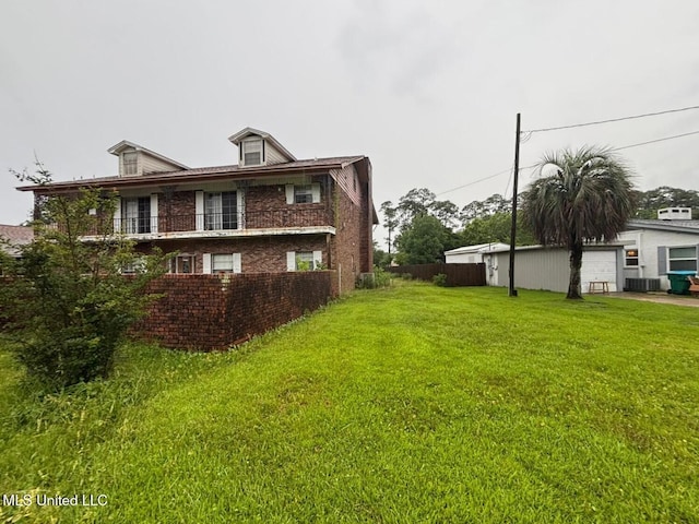 4805 Washington Ave, Gulfport, MS 39507 - view of home's exterior featuring brick siding, a garage, and a balcony
