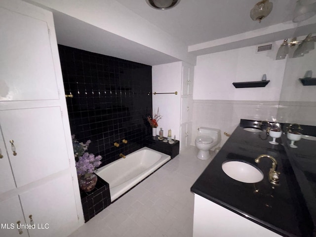 4805 Washington Ave, Gulfport, MS 39507 - full bathroom with double vanity, tile walls, wainscoting, and tile patterned floors