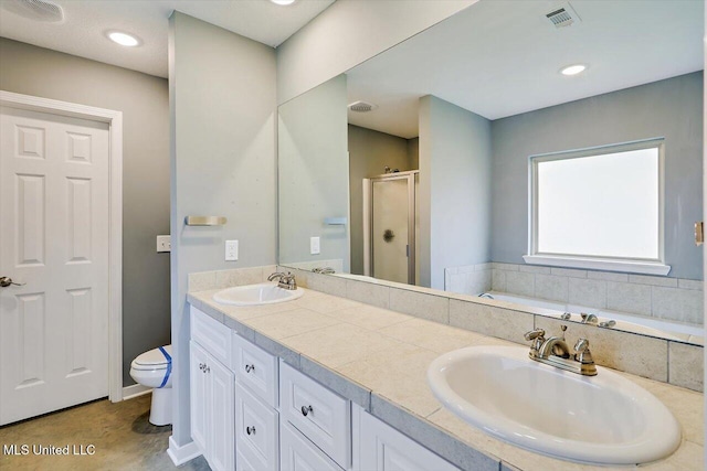 bathroom featuring a shower stall, toilet, double vanity, and a bath