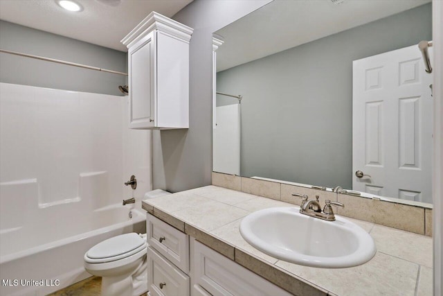 full bathroom featuring toilet, vanity, and tub / shower combination