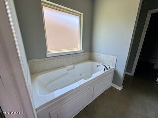 bathroom with a garden tub