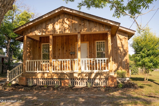 rustic home featuring covered porch