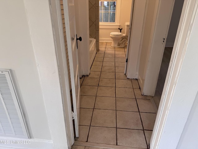 full bath with tile patterned floors and toilet