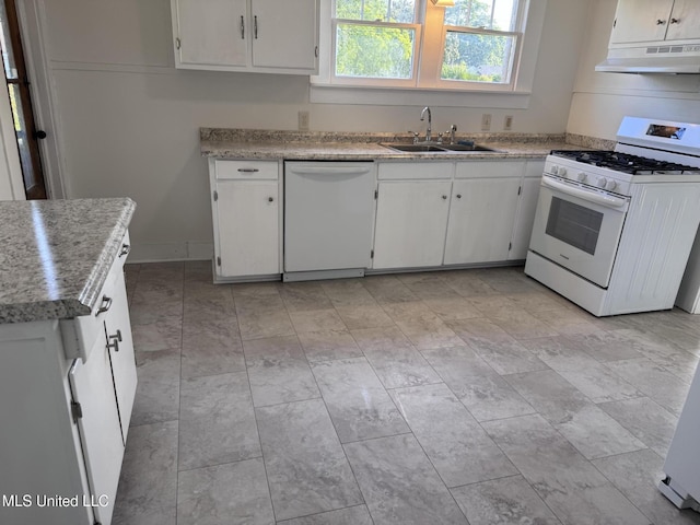 kitchen featuring white appliances, under cabinet range hood, a sink, white cabinetry, and light countertops