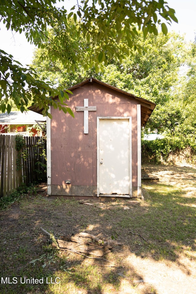 view of shed featuring fence