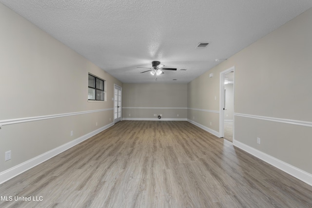 449 Klondyke Rd, Long Beach, MS 39560 - empty room featuring a textured ceiling, baseboards, ceiling fan, visible vents, and wood finished floors