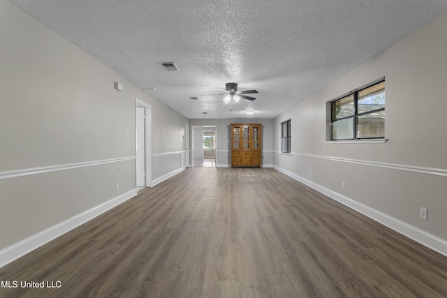 449 Klondyke Rd, Long Beach, MS 39560 - unfurnished living room featuring a textured ceiling, visible vents, a ceiling fan, dark wood-style floors, and baseboards