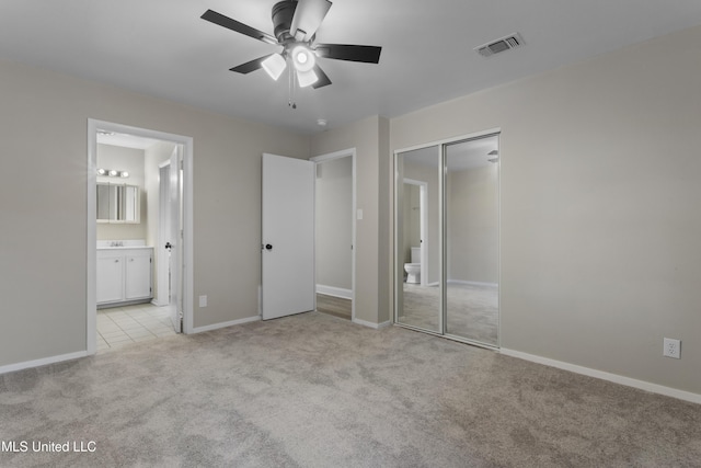 449 Klondyke Rd, Long Beach, MS 39560 - unfurnished bedroom featuring a closet, baseboards, ensuite bath, visible vents, and light colored carpet