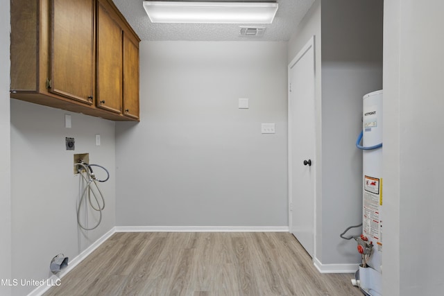 449 Klondyke Rd, Long Beach, MS 39560 - clothes washing area with cabinet space, light wood-type flooring, electric dryer hookup, and hookup for a washing machine