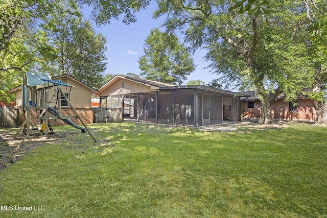 449 Klondyke Rd, Long Beach, MS 39560 - view of yard featuring a sunroom, a playground, and fence