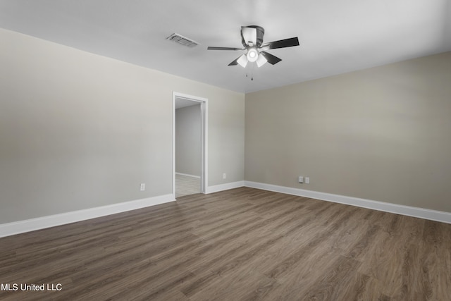 449 Klondyke Rd, Long Beach, MS 39560 - empty room featuring dark wood finished floors, visible vents, baseboards, and a ceiling fan