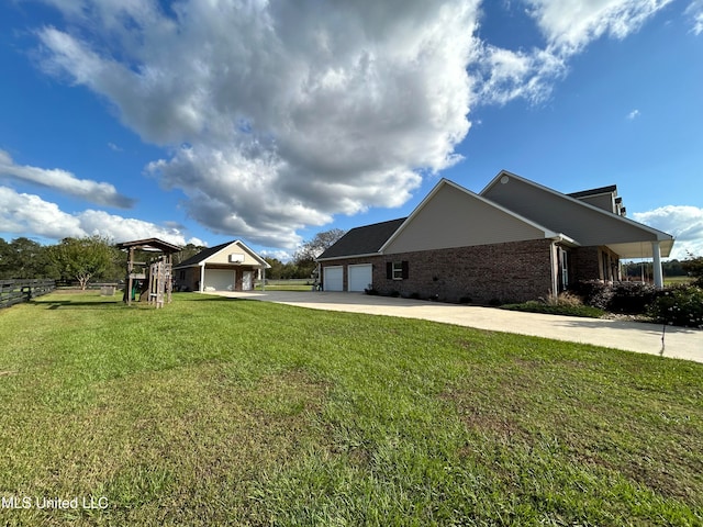 view of side of home featuring a garage, a playground, and a yard