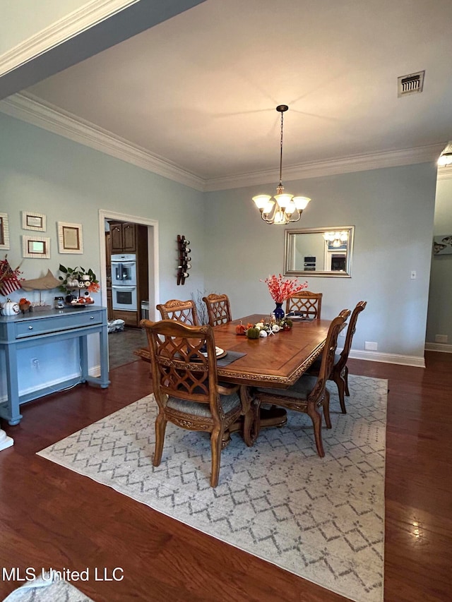 dining room featuring a notable chandelier, dark hardwood / wood-style floors, and crown molding