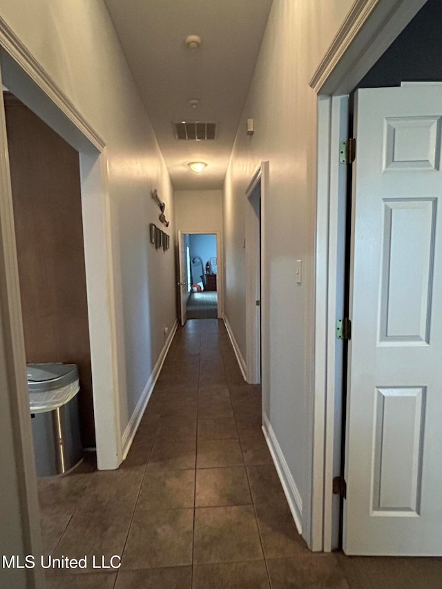 corridor with dark tile patterned floors