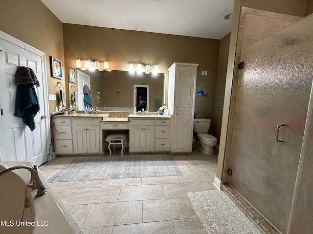 bathroom featuring walk in shower, tile patterned floors, vanity, and toilet