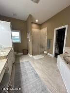 bathroom with a washtub and vanity