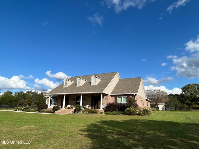 cape cod home featuring a front yard