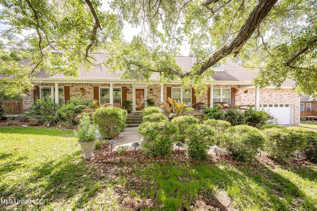 1344 Diller Rd, Ocean Springs, MS 39564 - view of front of property with brick siding, a garage, a shingled roof, and a front yard