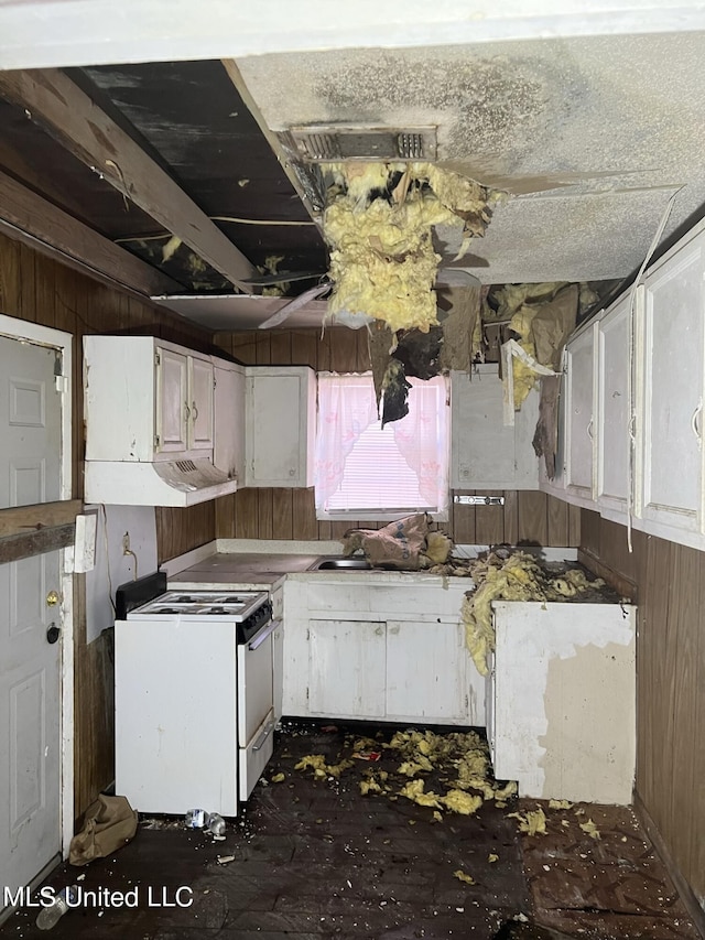 514 Lincoln Ave, Indianola, MS 38751 - kitchen featuring gas range gas stove, white cabinets, and wood walls