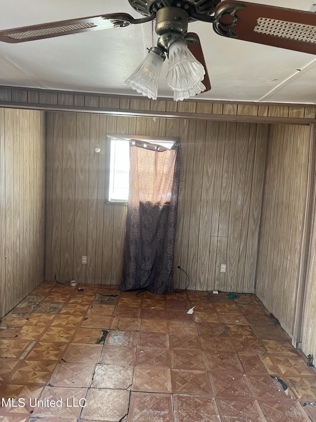 514 Lincoln Ave, Indianola, MS 38751 - spare room featuring wood walls and ceiling fan