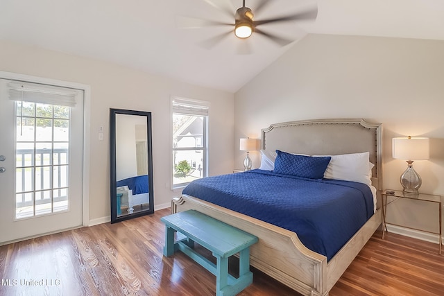 bedroom with hardwood / wood-style flooring, lofted ceiling, multiple windows, and access to outside