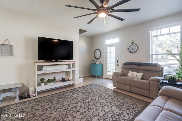 living room with a healthy amount of sunlight, light tile patterned floors, and ceiling fan