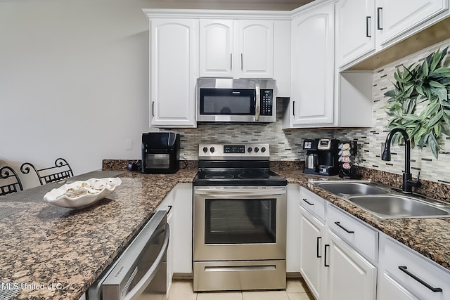 kitchen featuring white cabinetry, appliances with stainless steel finishes, sink, and decorative backsplash