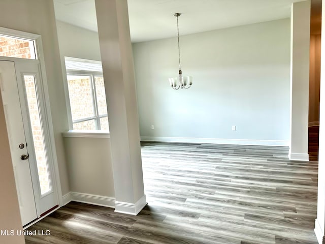 foyer featuring dark hardwood / wood-style flooring and a chandelier