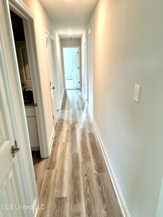 hall with light hardwood / wood-style flooring