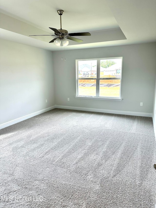 carpeted empty room featuring ceiling fan