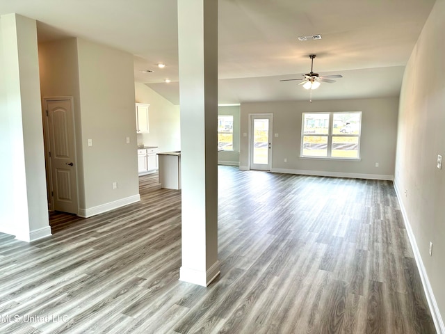 unfurnished living room featuring ceiling fan, light hardwood / wood-style flooring, and vaulted ceiling