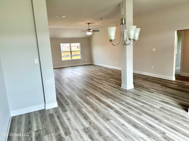 unfurnished dining area with hardwood / wood-style floors, ceiling fan with notable chandelier, and lofted ceiling