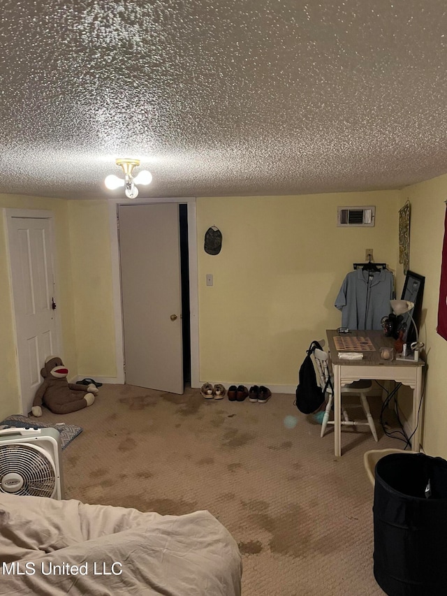 basement with carpet and a textured ceiling