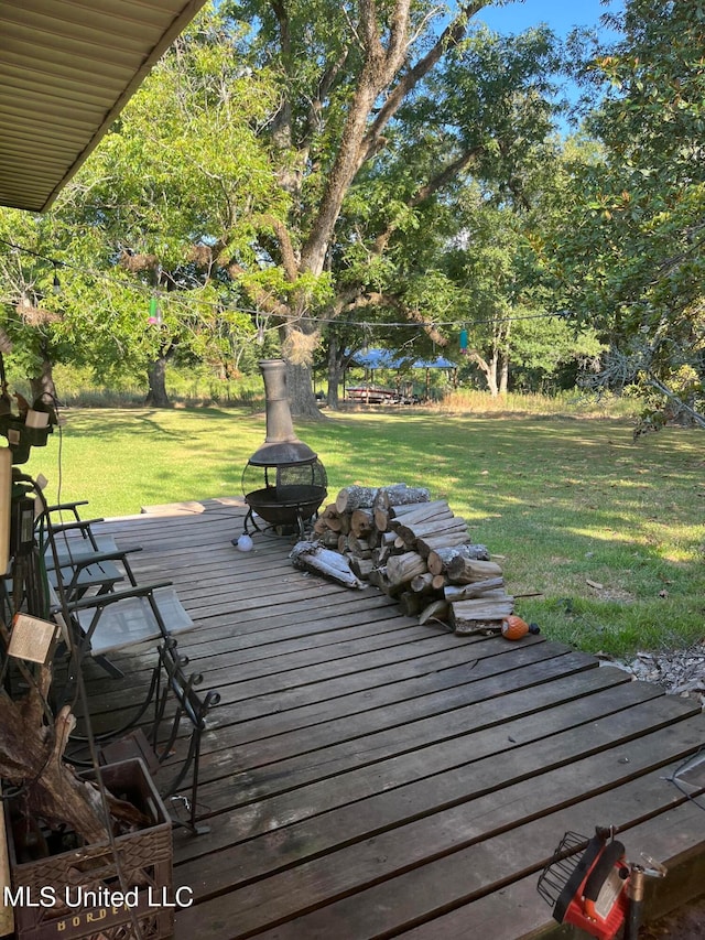 wooden deck featuring a yard