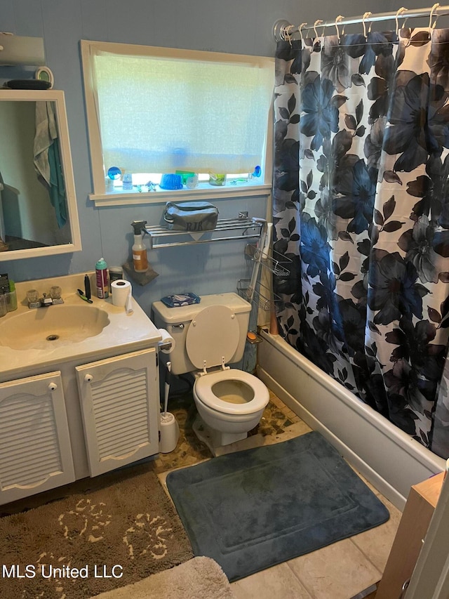 full bathroom with vanity, shower / tub combo, toilet, and plenty of natural light