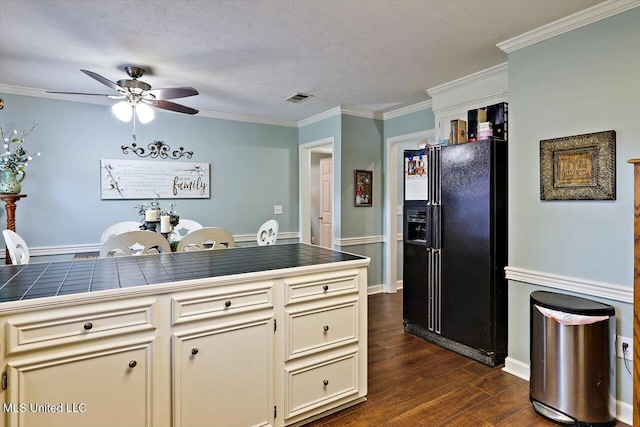 206 Southwind Dr, Richland, MS 39218 - kitchen featuring black fridge, tile countertops, ceiling fan, dark wood finished floors, and crown molding