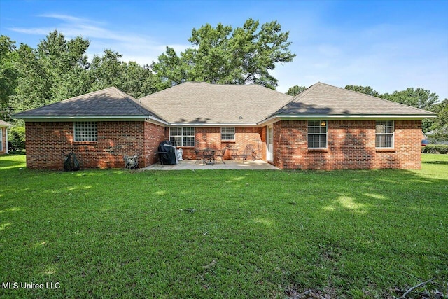 206 Southwind Dr, Richland, MS 39218 - rear view of house with a patio, a yard, brick siding, and a shingled roof