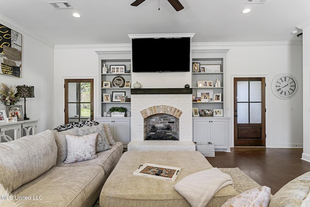 living room featuring a brick fireplace, crown molding, dark hardwood / wood-style floors, and ceiling fan