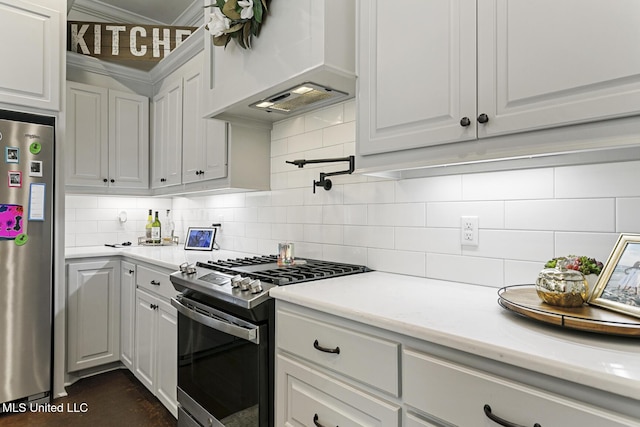 kitchen with premium range hood, white cabinetry, appliances with stainless steel finishes, tasteful backsplash, and ornamental molding