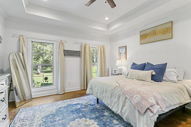 bedroom featuring crown molding, ceiling fan, and a tray ceiling