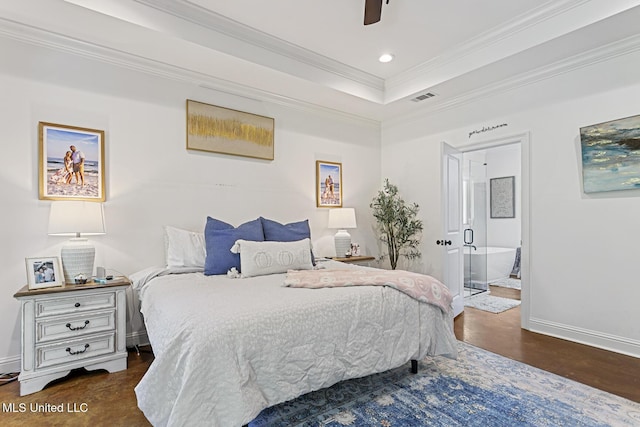 bedroom featuring connected bathroom, crown molding, dark hardwood / wood-style flooring, a raised ceiling, and ceiling fan