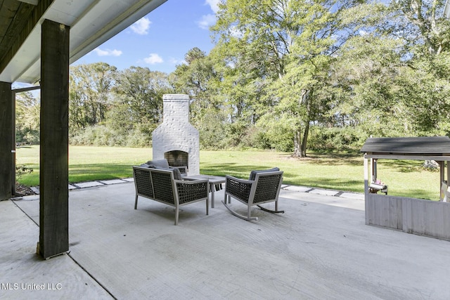 view of patio / terrace featuring an outdoor stone fireplace