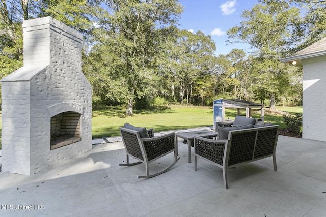 view of patio with an outdoor living space with a fireplace