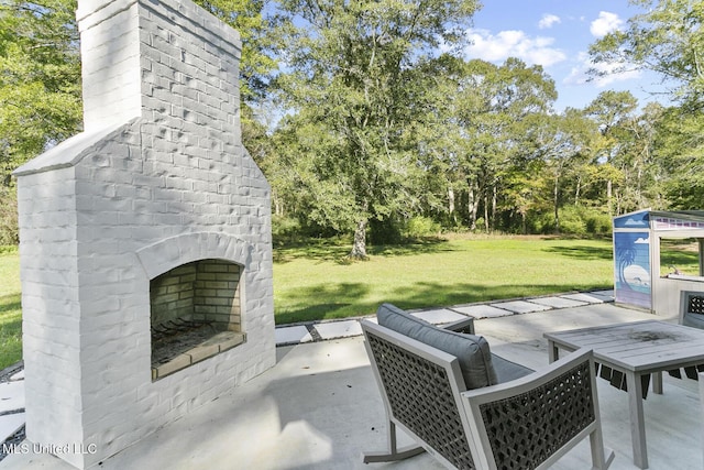 view of patio featuring an outdoor brick fireplace