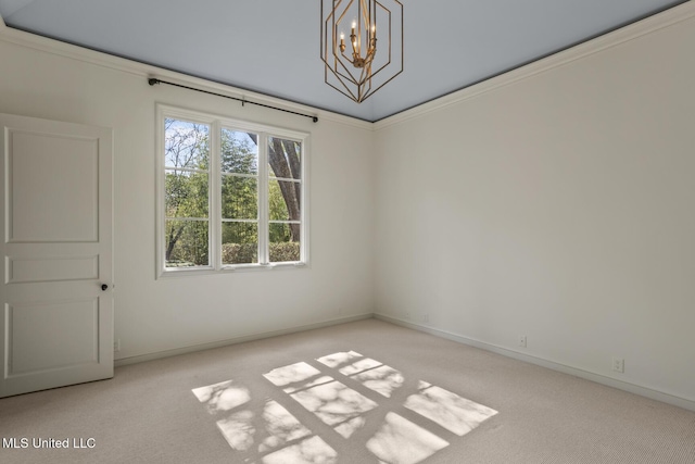 spare room featuring ornamental molding, a chandelier, and light carpet