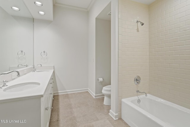 full bathroom with tiled shower / bath combo, vanity, crown molding, and toilet