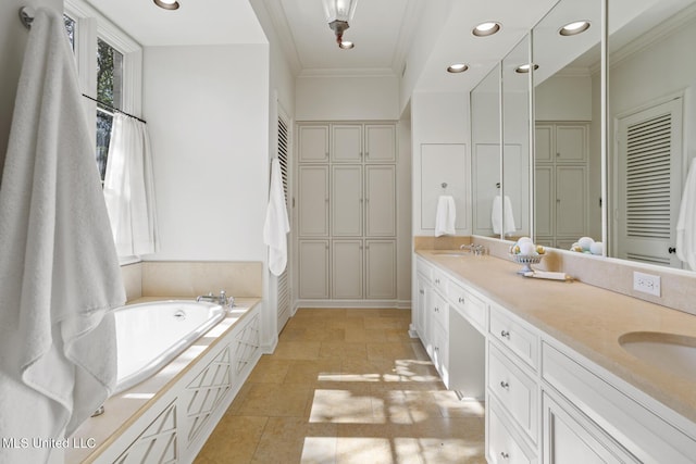 bathroom with vanity, a bathing tub, and ornamental molding