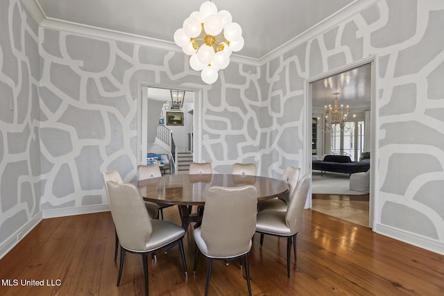 dining area featuring crown molding, wood-type flooring, and a chandelier