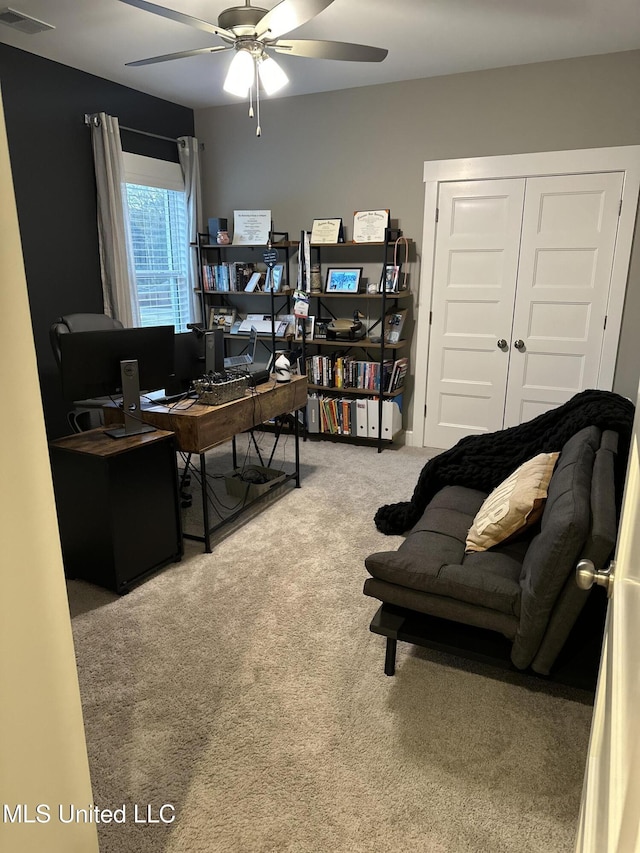 carpeted office with ceiling fan